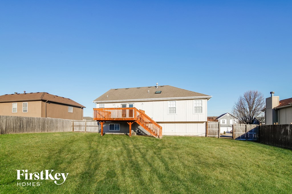 a backyard with a deck and a house