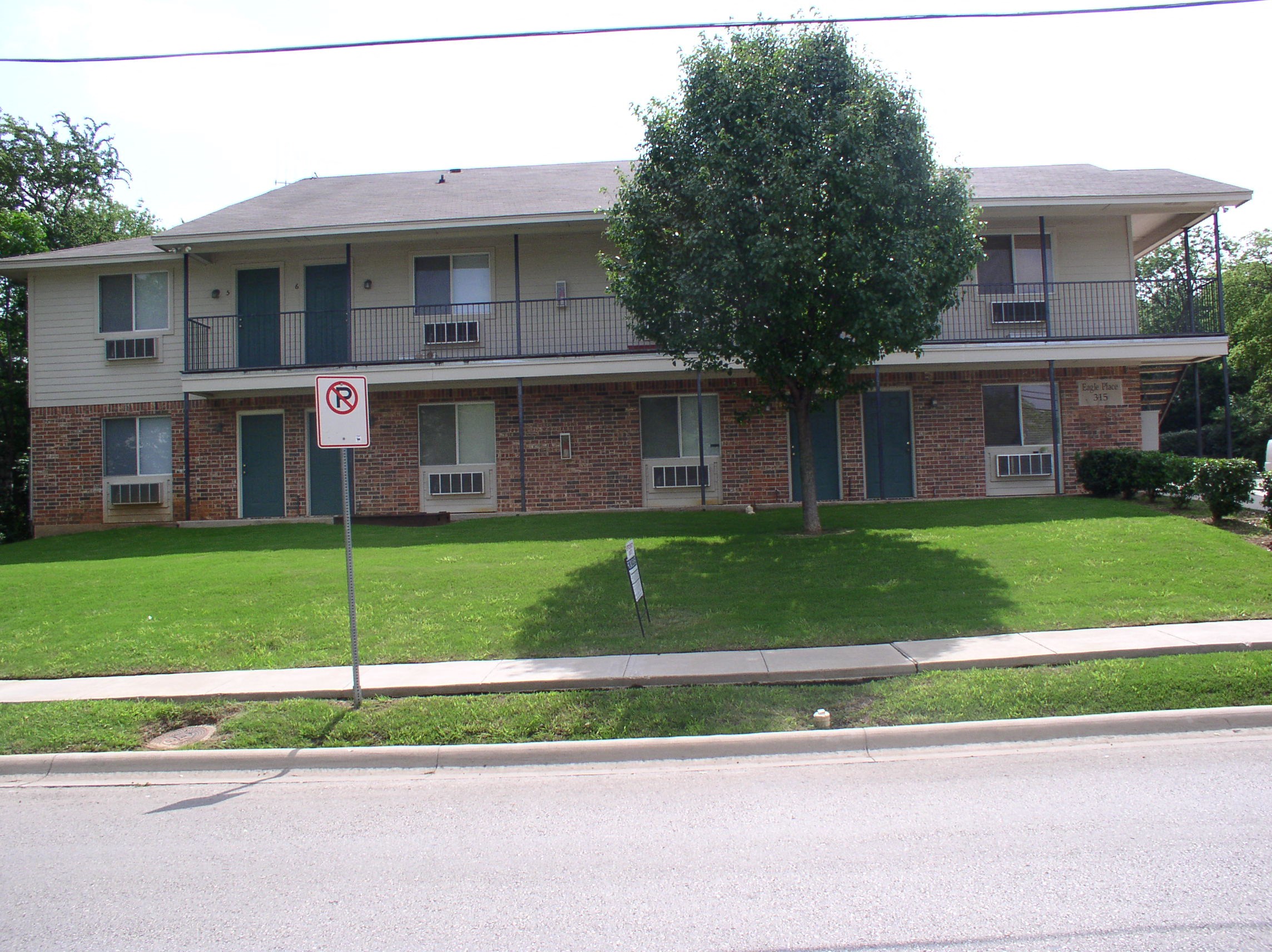 an image of an apartment building with a no parking sign