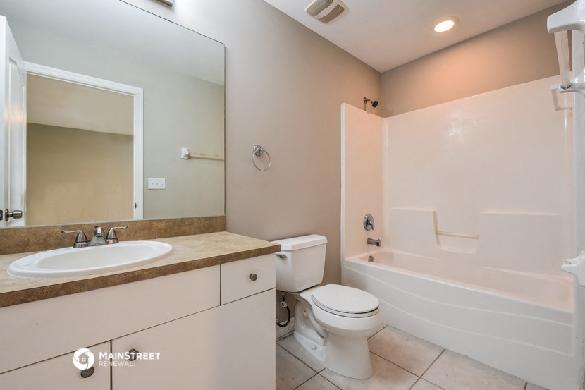 a bathroom with a sink toilet and a tub