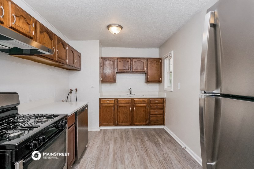 a kitchen with wooden cabinets and stainless steel appliances