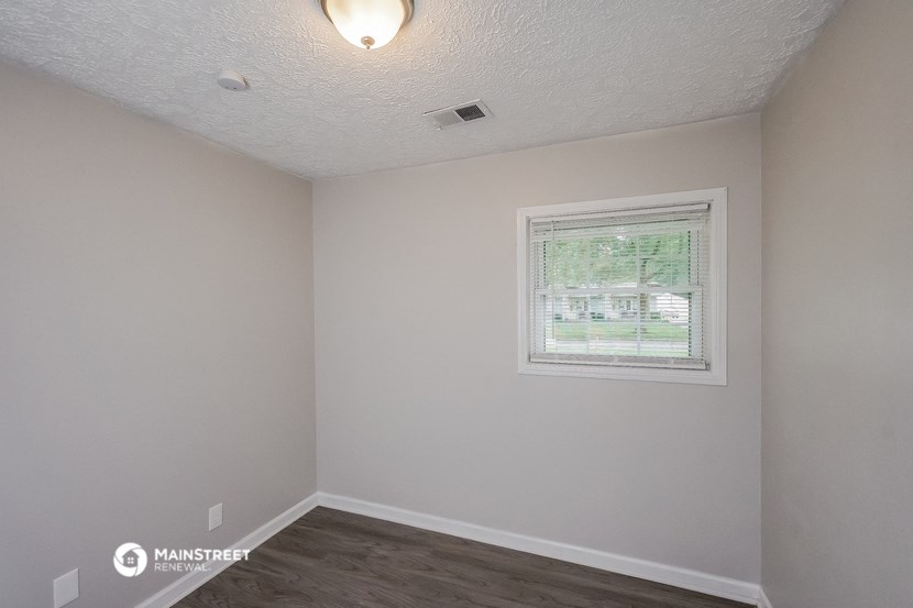 the living room of an empty house with a window