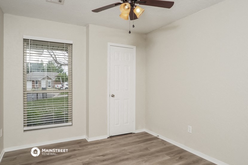 the living room of our studio apartment atrium with a window and a ceiling fan