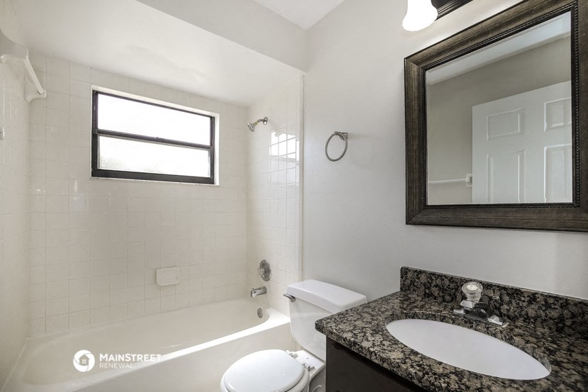 a bathroom with a sink and a toilet and a bath tub