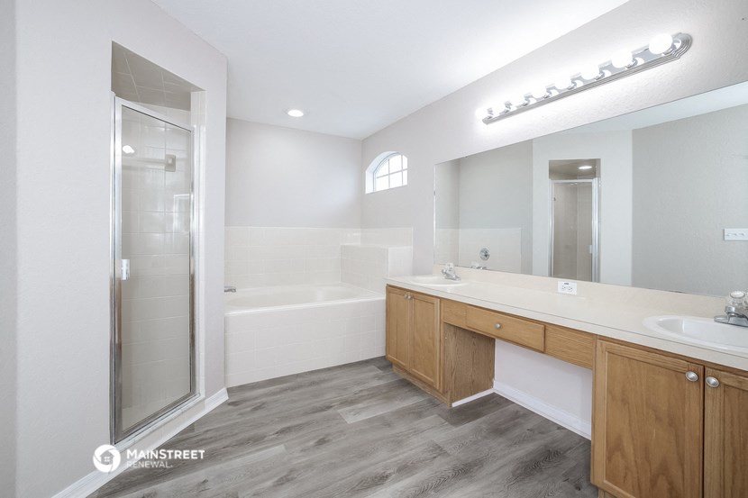 a bathroom with a shower and a sink and a mirror
