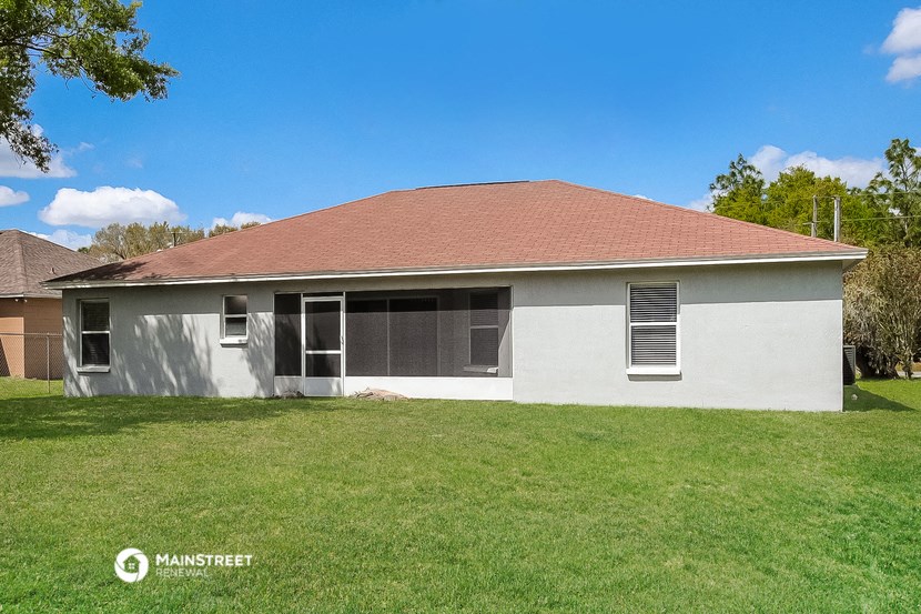 an old with a red roof on a grass field