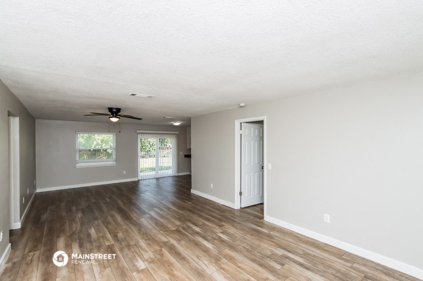 the living room and dining room of an open floor plan