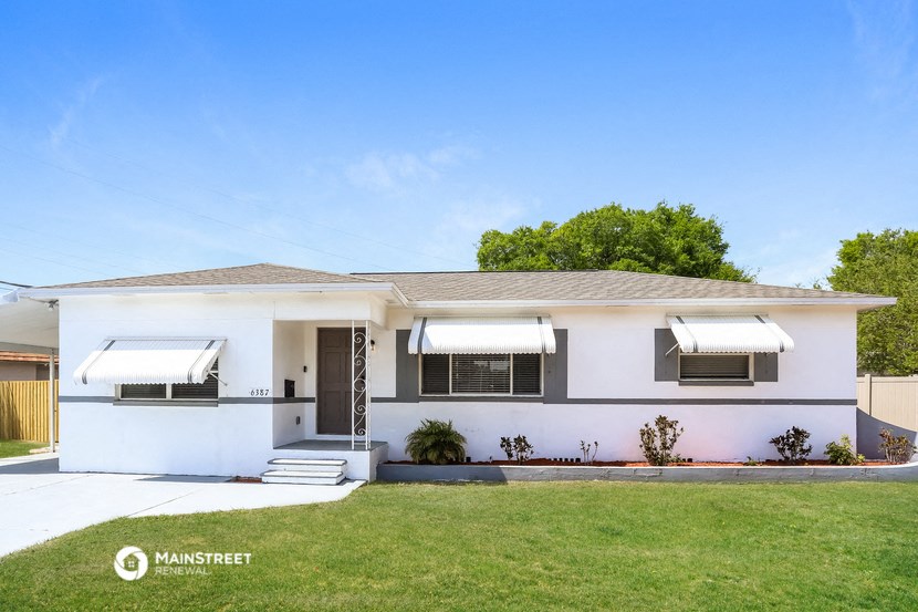 a white house with a lawn in front of it