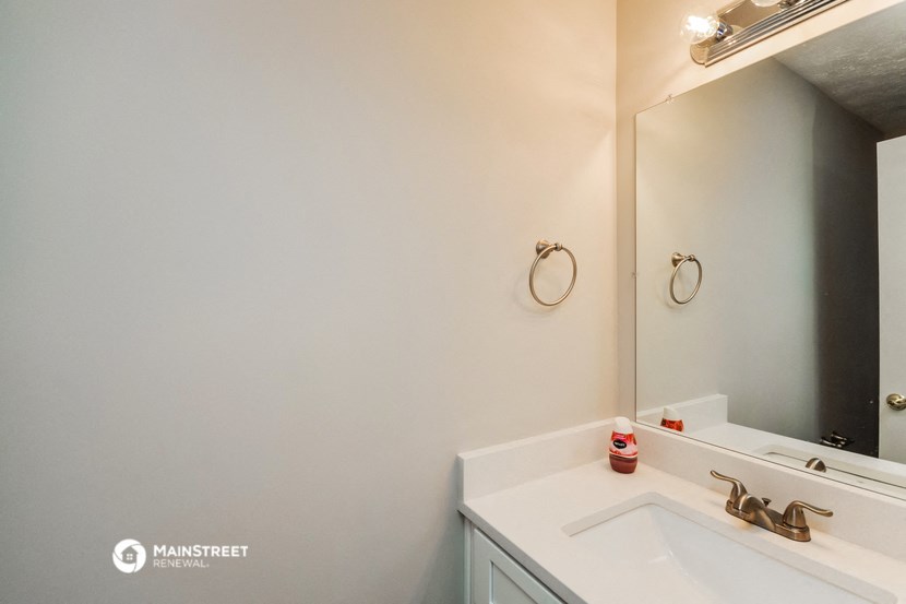 a white bathroom with a sink and a mirror