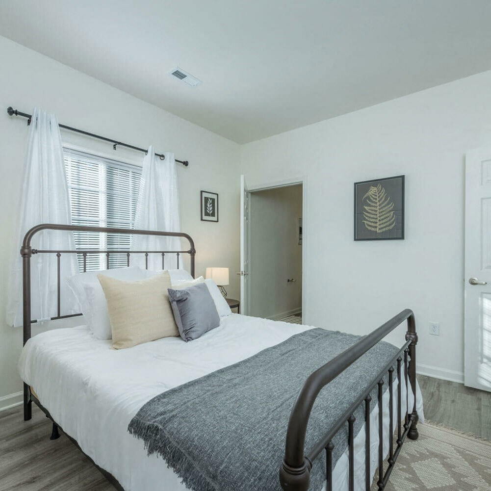 a bedroom with a bed and a window