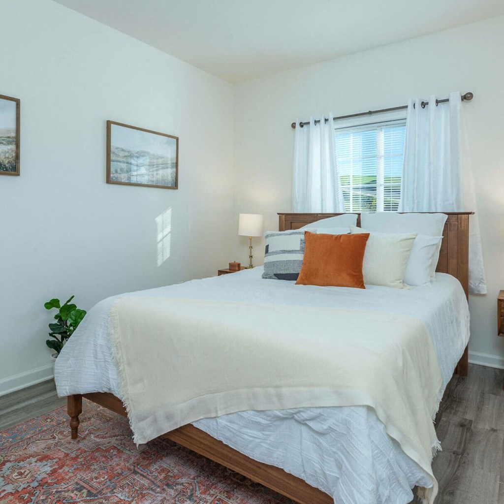 a bedroom with a bed and a window