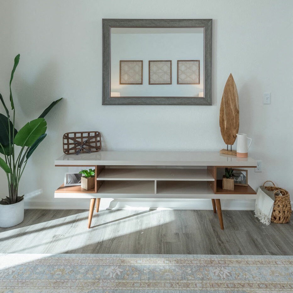 a living room with a table and a picture on the wall