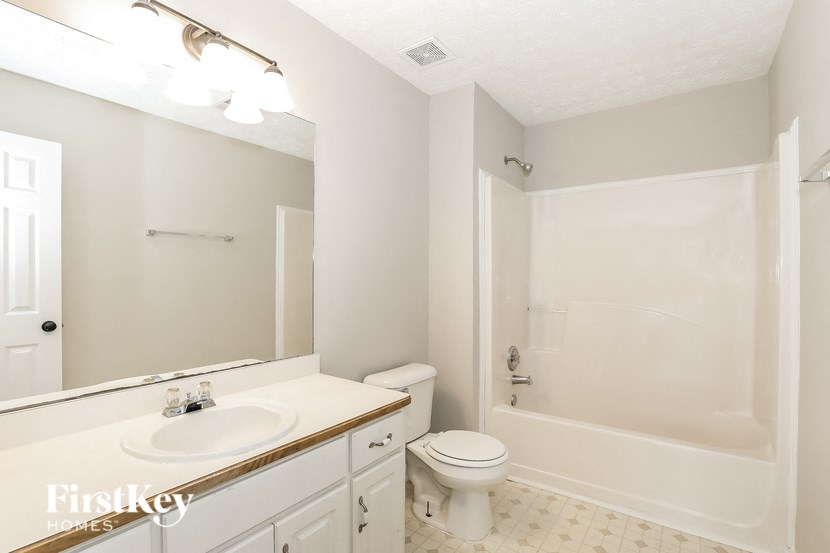 a bathroom with a sink toilet and a bath tub