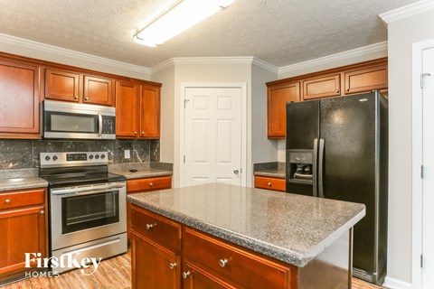 a kitchen with stainless steel appliances and granite counter tops
