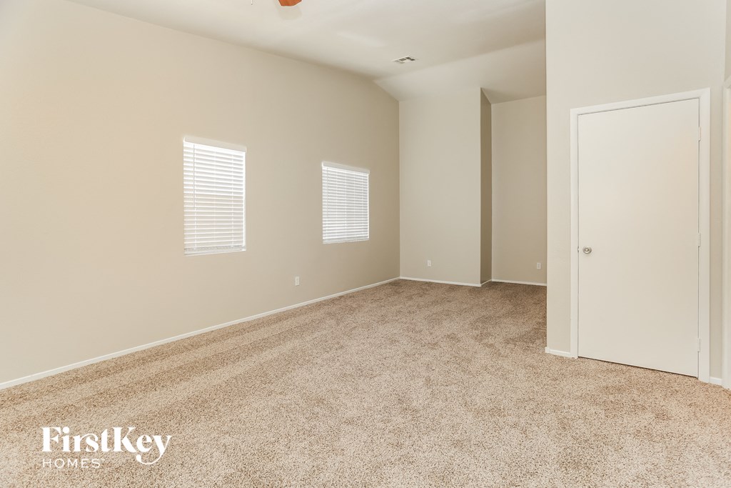 a bedroom with carpet and a door to a closet