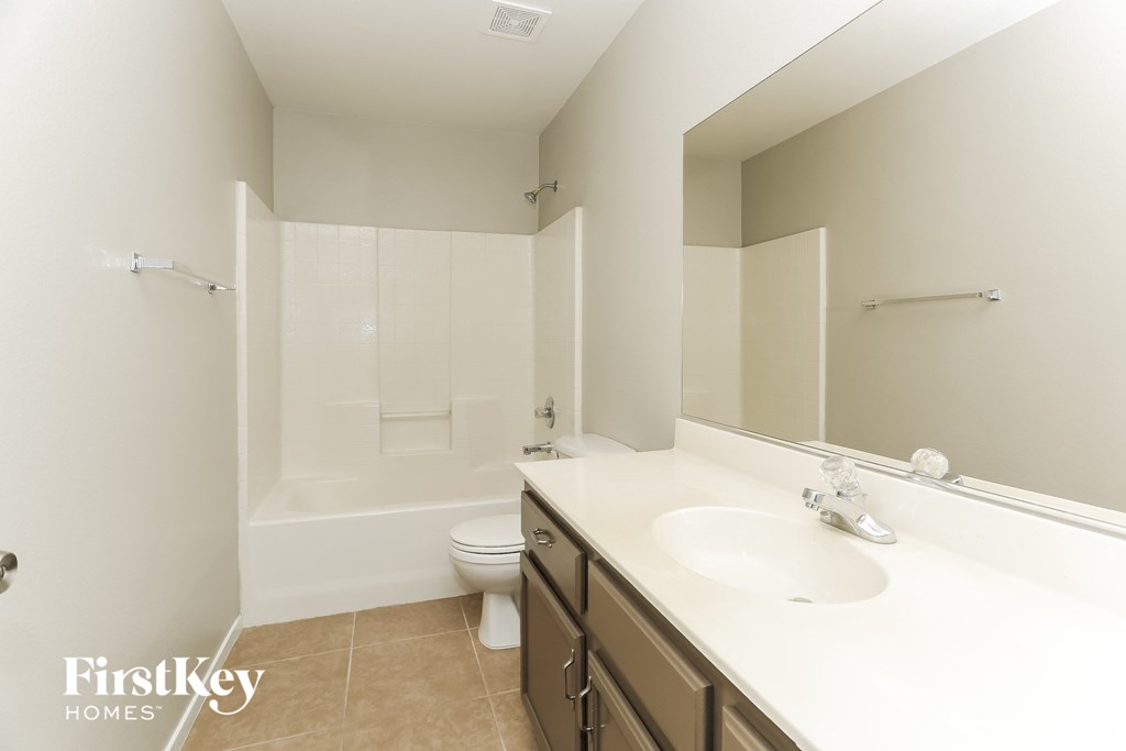 a bathroom with a sink and a toilet and a bath tub