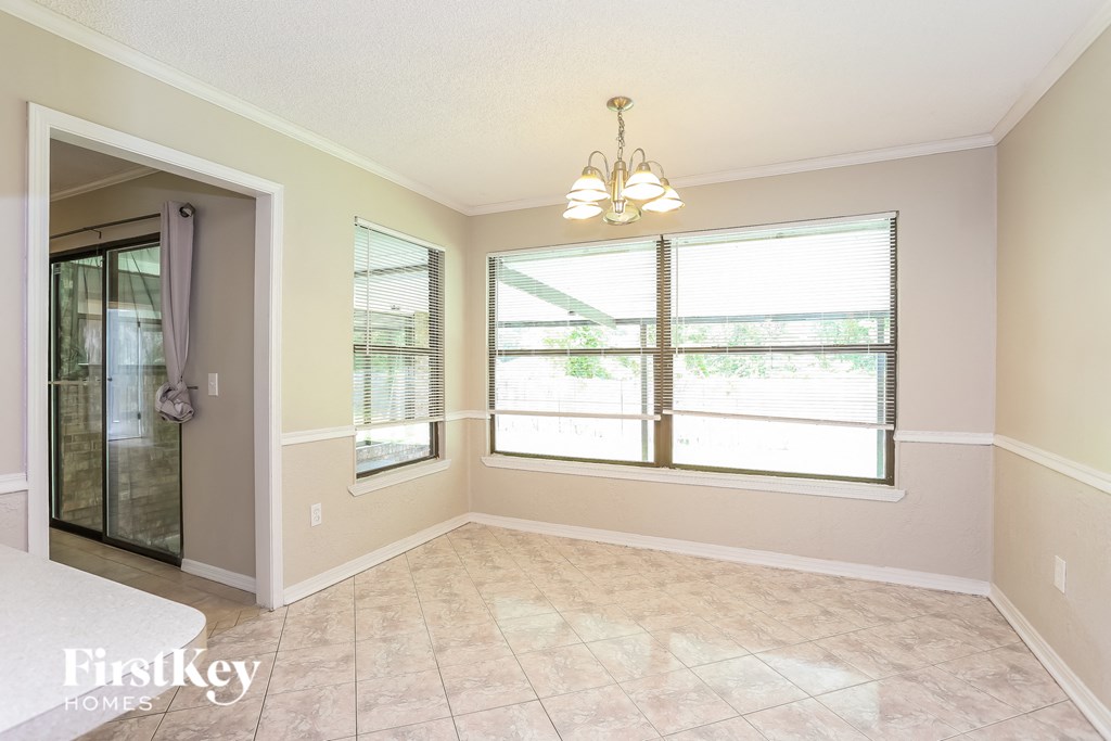 an empty dining room with a large window
