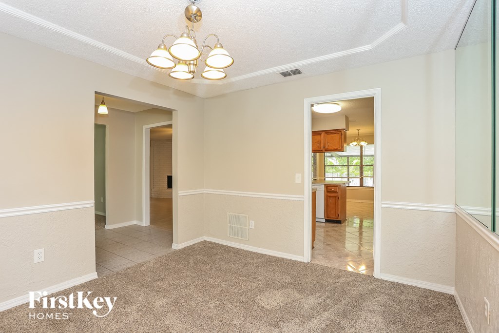 the living room and dining room are open to the kitchen and entryway