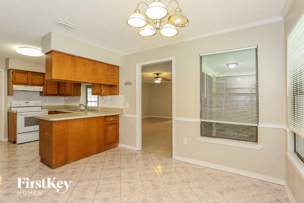 a kitchen with an island and a window and a door to a bathroom