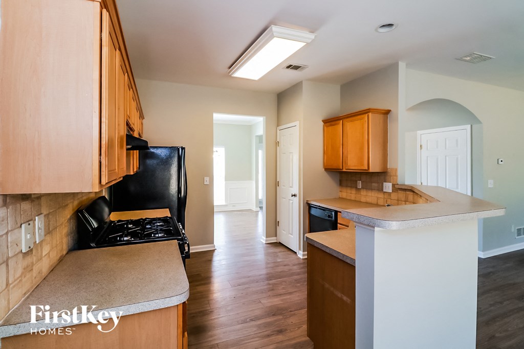 a kitchen with wooden cabinets and a white counter top