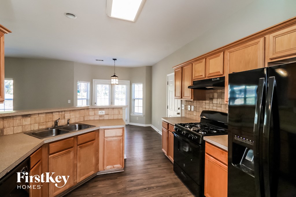 a kitchen with black appliances and wooden cabinets