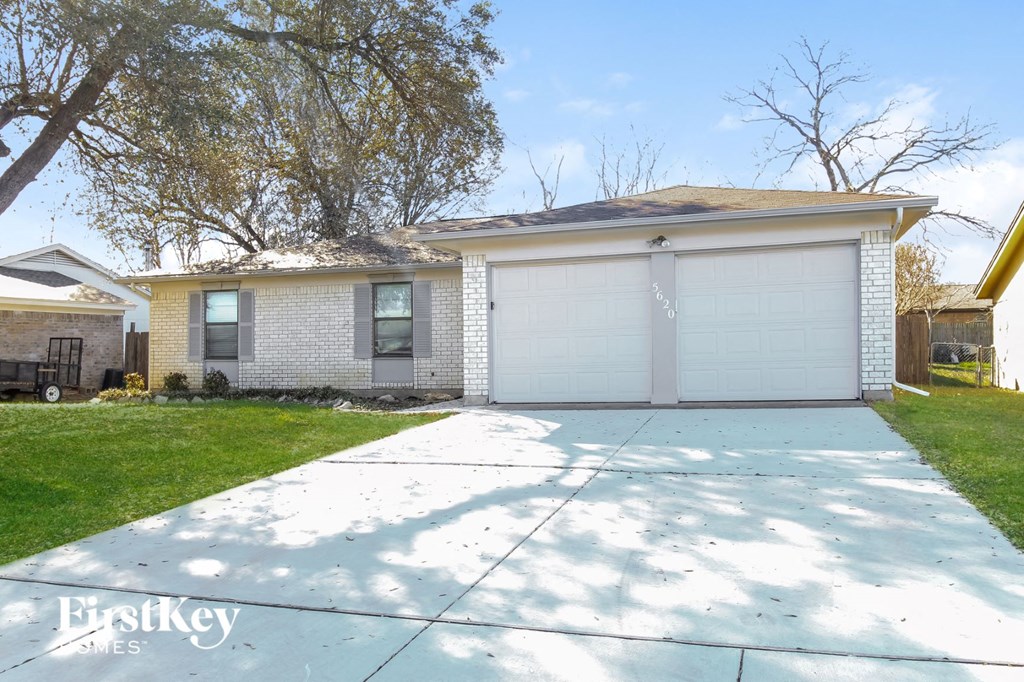 a white brick home with a white garage door