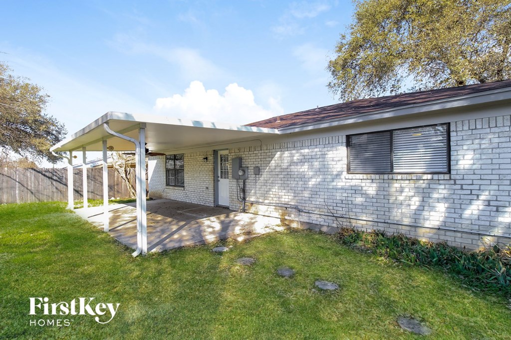 the front of a white brick house with a porch