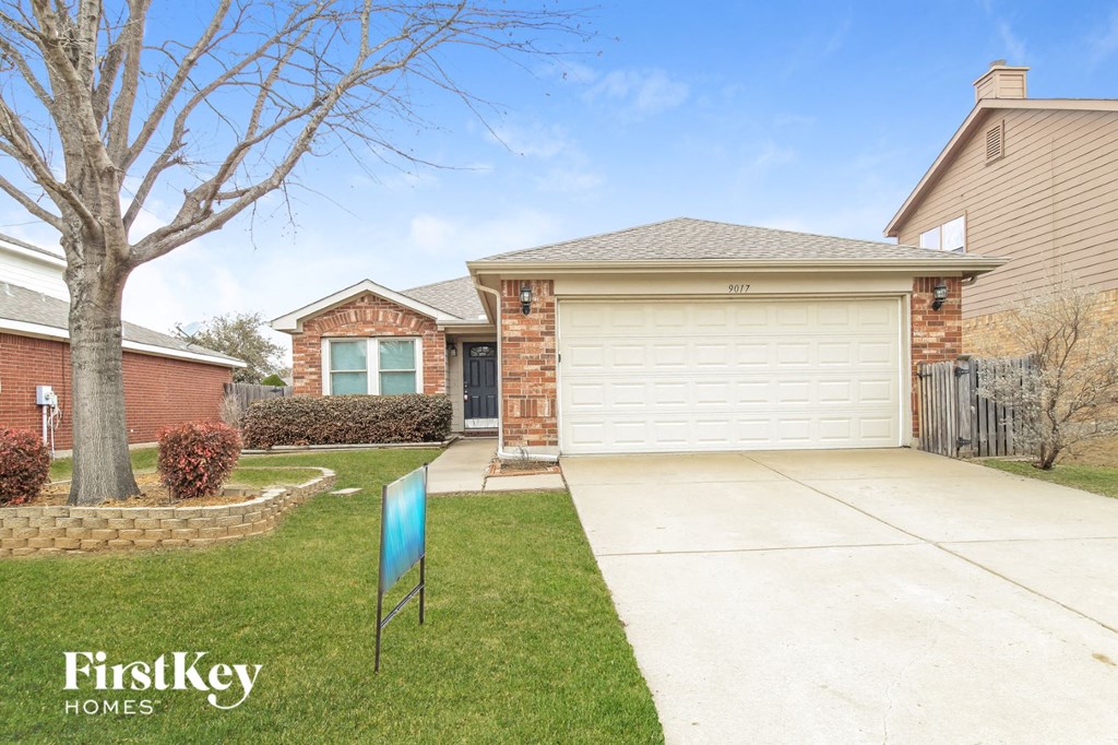 A house with a garage and a sign that says FirstKey Homes.