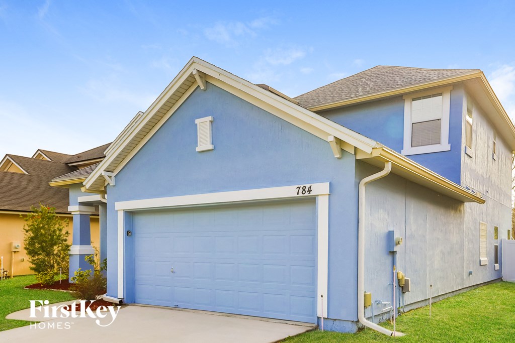 A blue house with a garage door numbered 784.