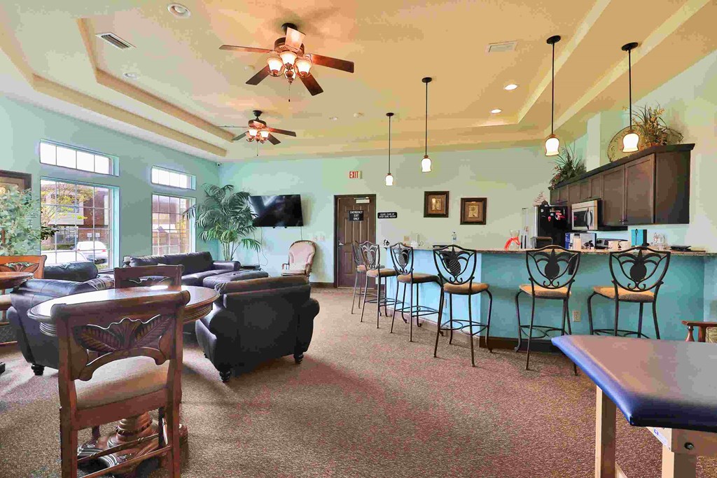 a large living room with tables and chairs and a bar