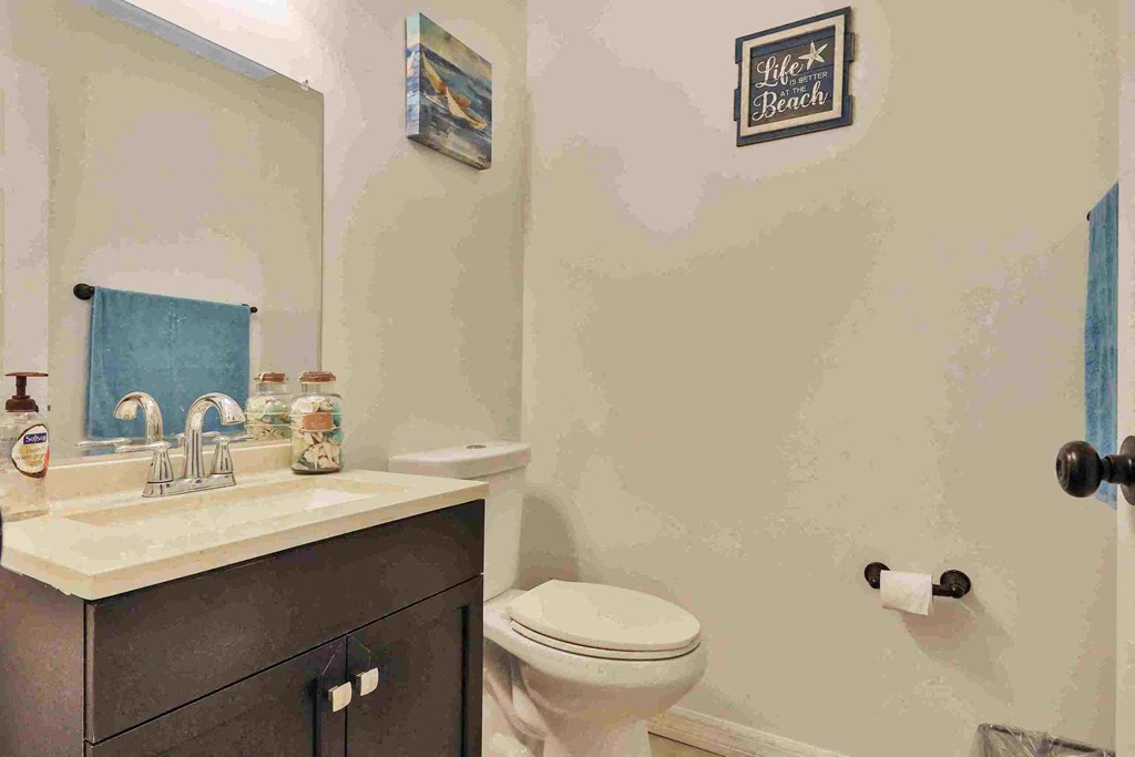 a bathroom with a sink toilet and a mirror