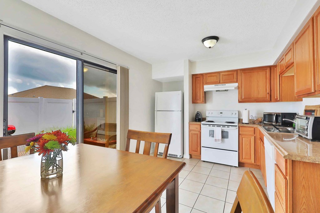 a kitchen and dining room with a wooden table