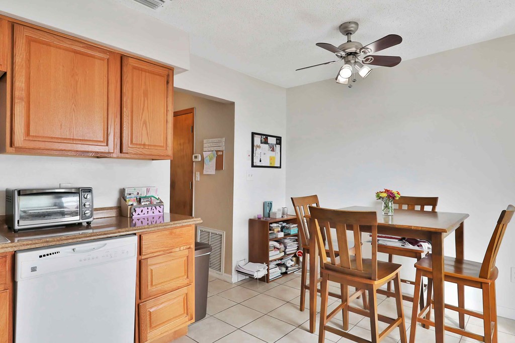 a kitchen and dining room with a table and chairs