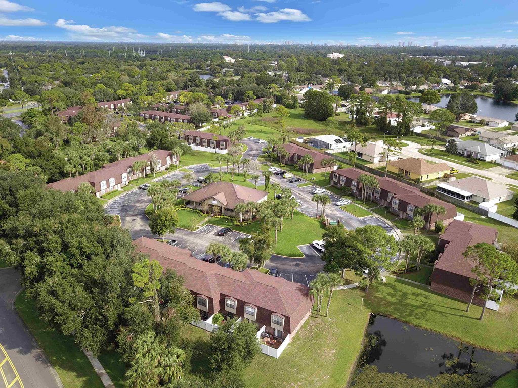 an aerial view of the campus with buildings and a body of water