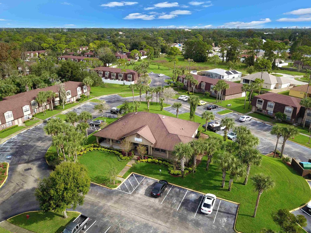an aerial view of a neighborhood with houses and parking lot