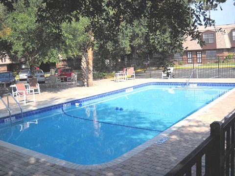 a large swimming pool with chairs around it