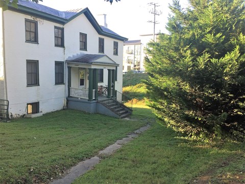 an old with a yard and a tree