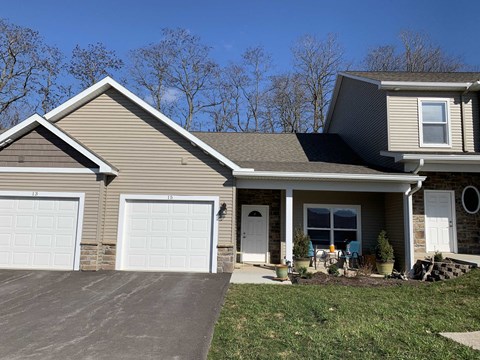 a tan house with a white garage door