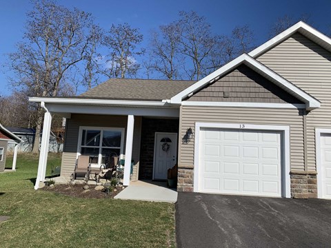 a tan house with a white garage door