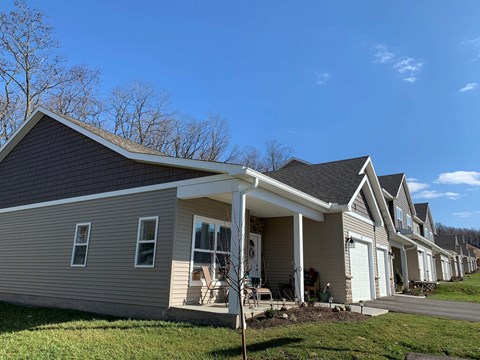 a row of houses with a blue sky in the background