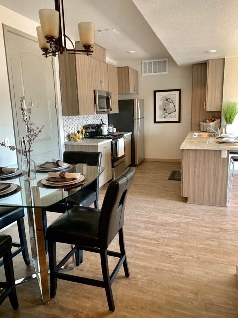a kitchen and dining room with a table and chairs