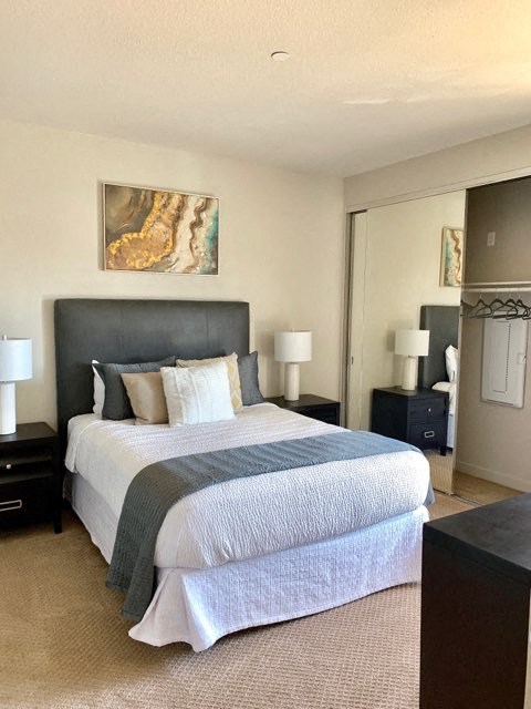 a bedroom with a bed and a mirror