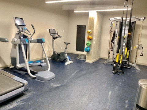 a gym with some exercise equipment on the floor