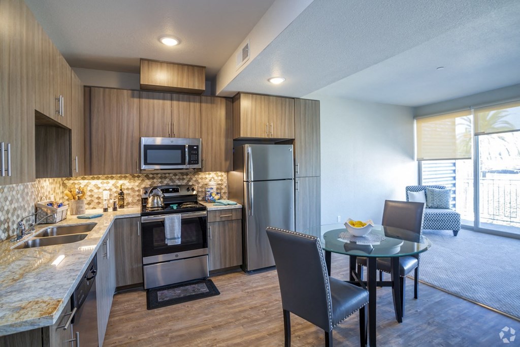 a kitchen and living room with a table and chairs