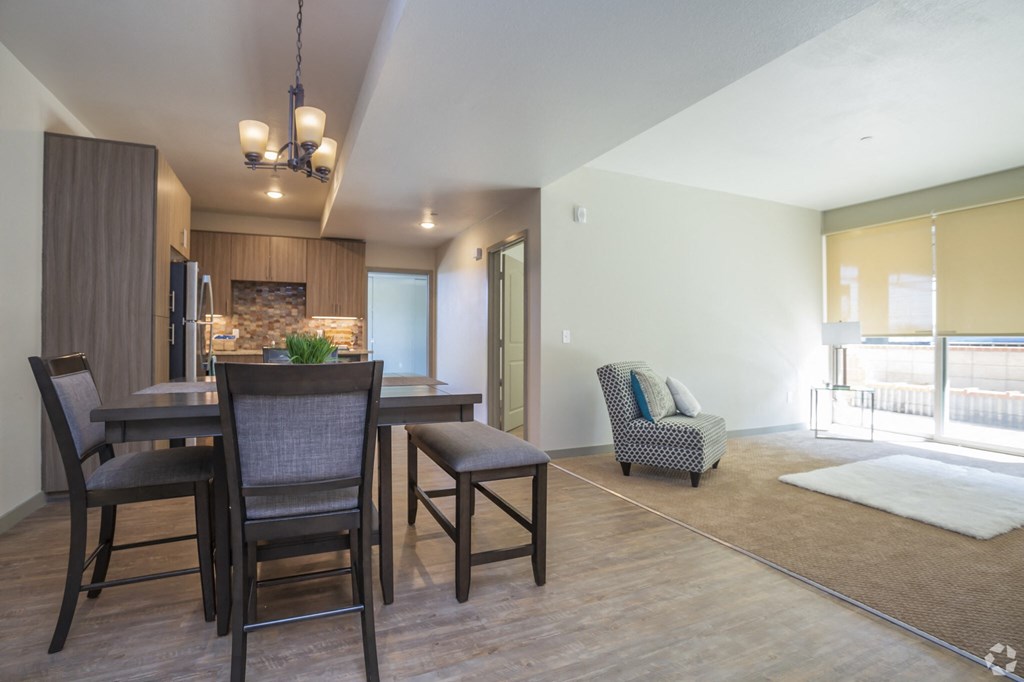 a dining room and living room with a table and chairs