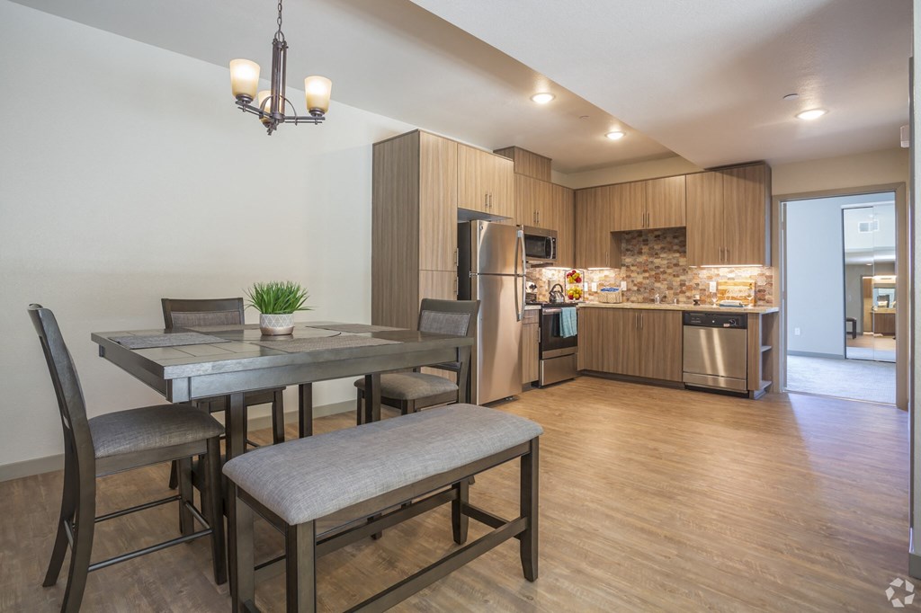 a kitchen and dining room with a table and chairs