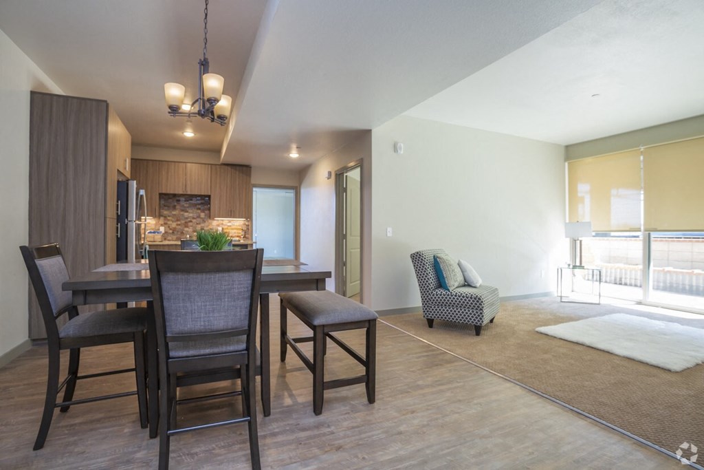 a dining room and living room with a table and chairs