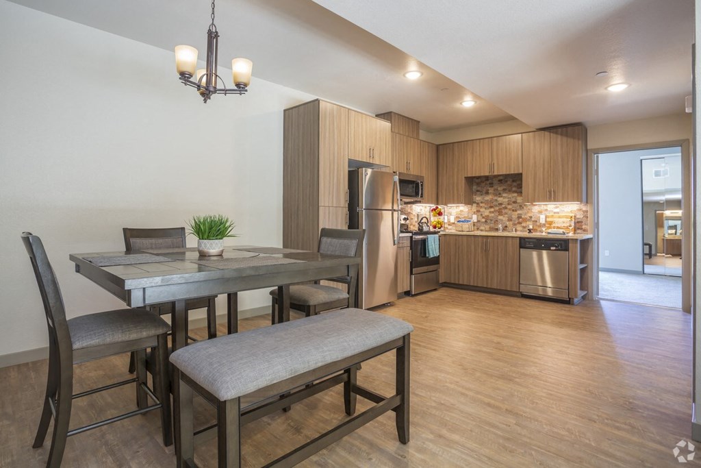 a kitchen and dining room with a table and chairs