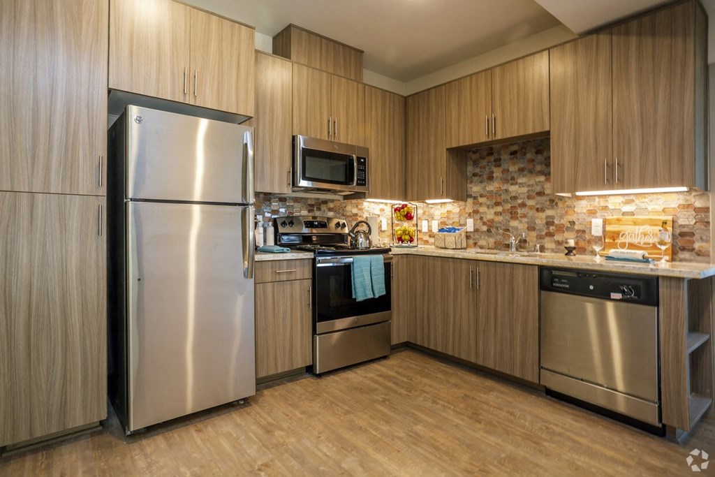 a kitchen with stainless steel appliances and wooden cabinets