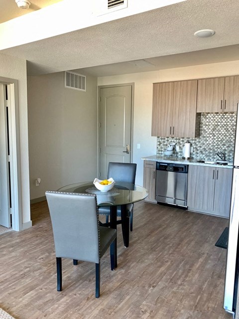 a kitchen and dining room with a table and chairs