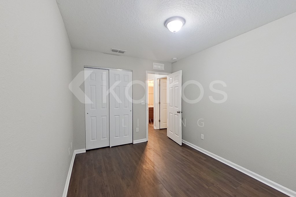 A room with a white door and a white wall.